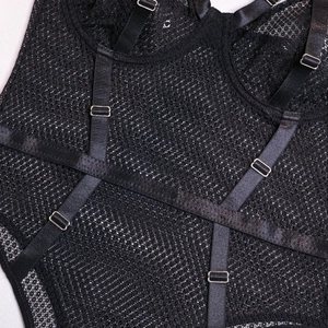Close-up of adjustable satin straps and silver metal buckles on black mesh lingerie