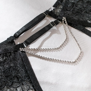 Close-up of black floral lace bodysuit featuring elegant double rhinestone chain details