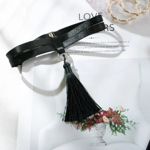 Close-up of a black double-layered choker with a silver metal ring and long silk tassels