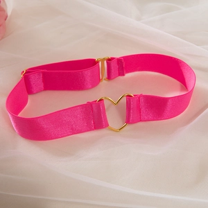 Detail of pink elastic choker with gold heart buckle and adjustable strap on white mesh