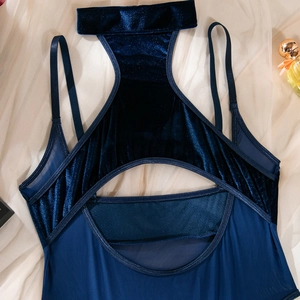 Close-up of navy velvet bodysuit featuring mesh panels and intricate cutout details