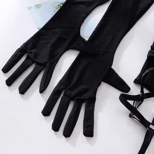 Détail de gants en résille noirs et harnais de jambe à brides avec boucles en métal