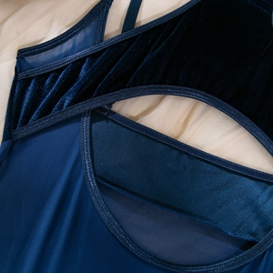Detail of blue velvet and mesh bodysuit with intricate cutout design and cross straps