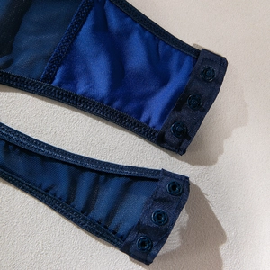 Detail of navy blue bodysuit with snap button closure and breathable mesh fabric stitching