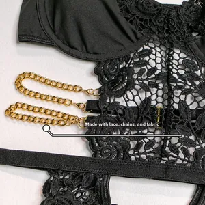 Detail of black floral lace fabric with elegant gold metal chain accents on lingerie