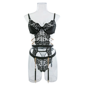 Detail of floral lace bodysuit with gold chain accents and adjustable garter straps
