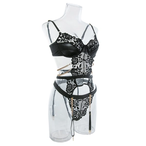 Detailed side view of black lace bodysuit featuring gold chain straps and garter loops