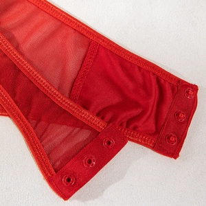 Detail view of red mesh bodysuit crotch featuring secure triple snap button closures