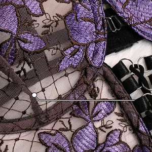 Detailed close-up of purple floral embroidery on brown mesh fabric with metal hardware