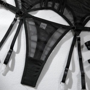 Detail of black sheer mesh lingerie set with satin trim and adjustable garter straps
