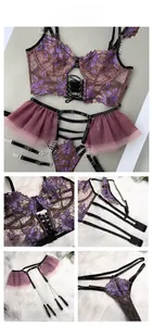 Detail view of purple floral lace embroidery on bodysuit with metal chain accents