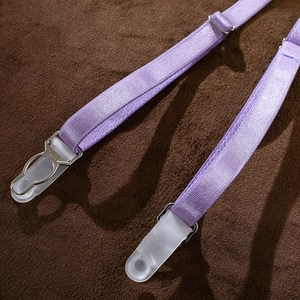 Close-up of purple elastic garter strap with adjustable silver metal buckle and clear clip