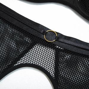 Detail view of black mesh bodysuit featuring a gold metal ring and elastic piping design