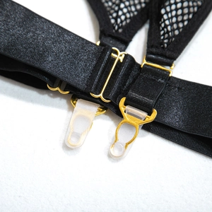 Detail of black satin garters with golden metal adjusters and silicone anti-slip clips