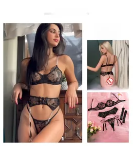 Detail view of black floral lace lingerie set with silver chain straps and garter belt