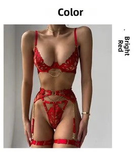 Detailed macro view of red lace lingerie set featuring golden metal chain accessories