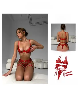 Detail view of red lace lingerie set with golden chain straps and intricate embroidery