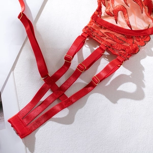 Close-up of red flame embroidery with delicate lace and gold metal hardware