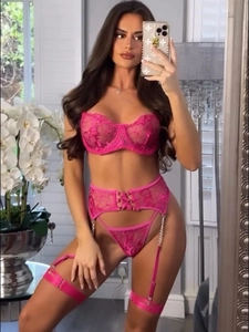 Detailed embroidery and metal chains on rose red lace bodysuit with waist cincher
