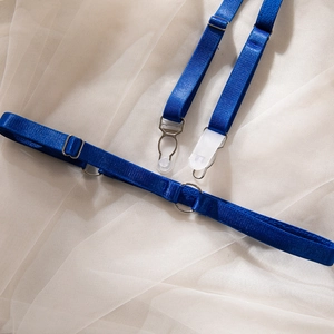 Detail of adjustable royal blue lace lingerie garter straps with silver metal hardware