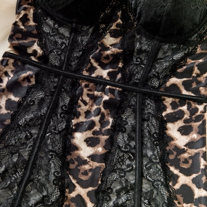 Close-up of leopard print fabric and black floral lace stitching on a corset dress