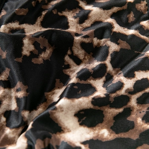 Macro shot of high-stretch leopard print fabric with dense texture for fashion apparel