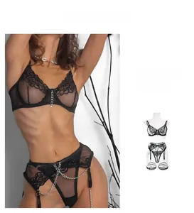 Detailed embroidery and silver chain links on a black lace lingerie set with garters