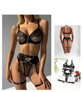 Detail of sexy black lace lingerie set with metal chains and floral embroidery