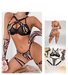 Detail of zebra print lingerie set with cross strap bra, matching gloves and leg rings