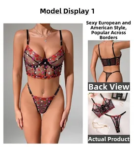Close-up of sheer black lace lingerie set with red heart embroidery and underwire support