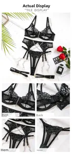 Detail of black lace lingerie set with metal chains and delicate floral embroidery