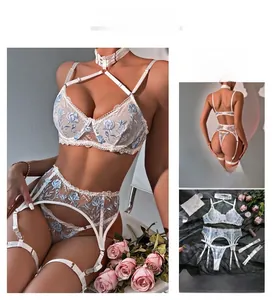 Detail view of white lace lingerie set with blue floral embroidery and garter straps