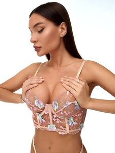 Detailed close-up of semi-transparent mesh bra with floral embroidery and underwire support