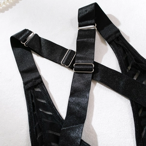Detail of adjustable satin straps with silver buckles and striped mesh on black bodysuit