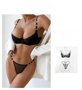Detail view of black sheer mesh lingerie set with golden rings and underwire cups