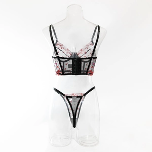 Close-up of sheer black lace lingerie set with red heart embroidery and fine mesh details