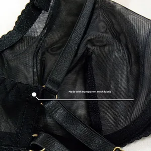 Close-up of black sheer mesh bra with delicate lace trim and gold metal ring detail