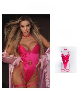 Detail of fluorescent pink satin bodysuit featuring steel ring cut-outs and heart accents