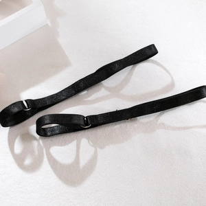 Detail of adjustable sparkling black elastic straps with silver metal hooks and sliders