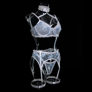 Close-up of white lace lingerie set with blue floral embroidery and adjustable straps