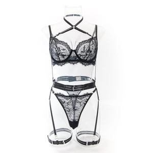 Detail of black floral lace lingerie set with strappy garter belt on mannequin