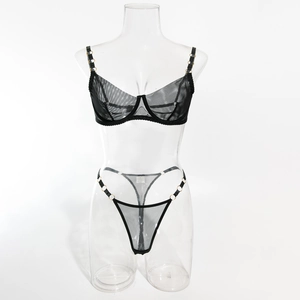 Detail of black mesh lingerie set featuring golden metal rings and wired half cups
