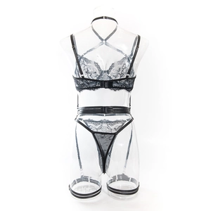 Detail of black lace lingerie set with sheer mesh and strappy cross-back design