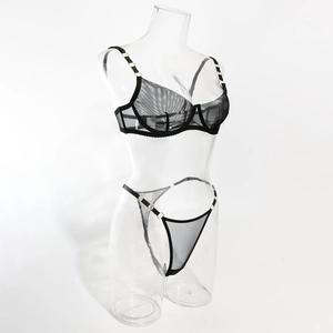 Detail of sheer black mesh lingerie set with gold ring accents and underwire bra