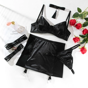 Detailed flat lay of 5-piece black satin lingerie set with garter belt and red roses