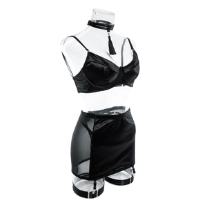 Detailed view of black satin lingerie set with mesh skirt garter and fringe choker