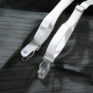 Detail of adjustable garter straps with white elastic webbing and metal clasps