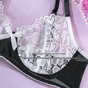 Detail of transparent heart lace and black mesh fabric on a stylish maid lingerie bodysuit