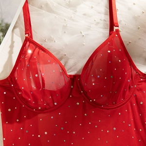 Detailed shot of red mesh corset top with colorful rhinestones and underwire support