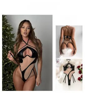 Close-up of sexy PU leather teddy with mesh cutouts and garter clips on feather rug